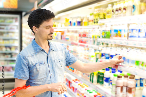Photo: man in a supermarket buying milk shake man in a supermarket buying milk shake