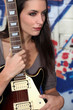 Photo: young woman holding a guitar young woman holding a guitar