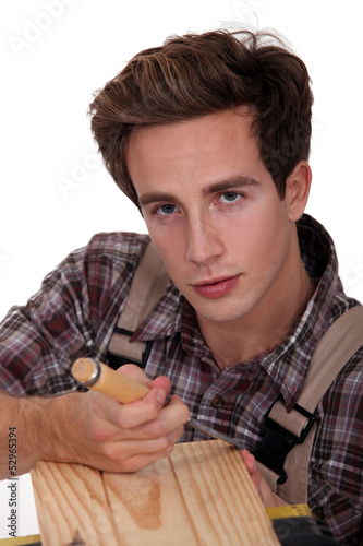 Photo: A carpenter using a chisel. A carpenter using a chisel.