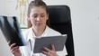 Female doctor with tablet computer looking at xray picture