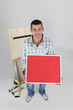 Photo: Carpenter holding up picture frame Carpenter holding up picture frame