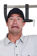 Man with his head in a vice