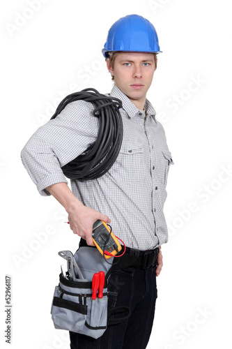 Photo: Electrician carrying a voltmeter Electrician carrying a voltmeter