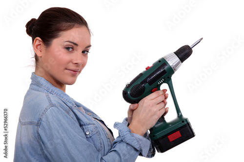 Photo: Woman holding drill on white background Woman holding drill on white background