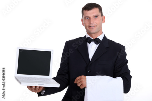 Photo: Waitor holding laptop Waitor holding laptop