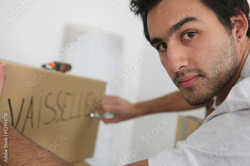 Photo: Man packing dishes Man packing dishes
