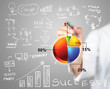 Photo: Businessman writing pie chart with any process in business work Businessman writing pie chart with any process in business work