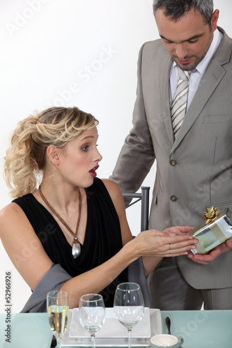 Photo: Surprised woman receiving a gift from her boyfriend Surprised woman receiving a gift from her boyfriend