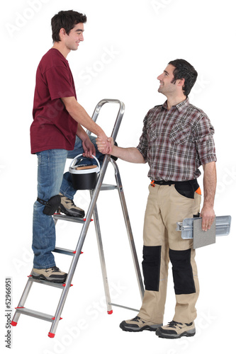 Photo: Two handymen shaking hands Two handymen shaking hands