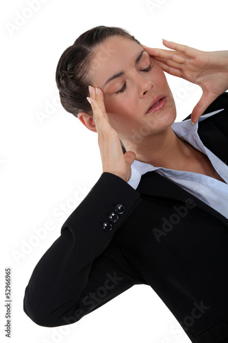 Photo: Woman suffering from a throbbing headache Woman suffering from a throbbing headache