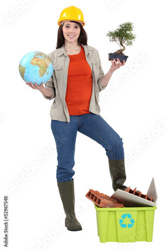 Photo: Cute brunette apprentice holding globe Cute brunette apprentice holding globe