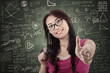Attractive female student show thumb up in class