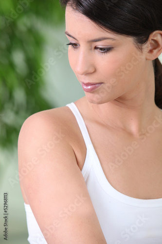 Photo: Attractive brunette wearing white vest Attractive brunette wearing white vest