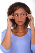 Young woman holding her hands to her head