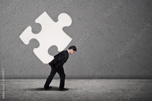 Photo: Businessman build puzzle Businessman build puzzle