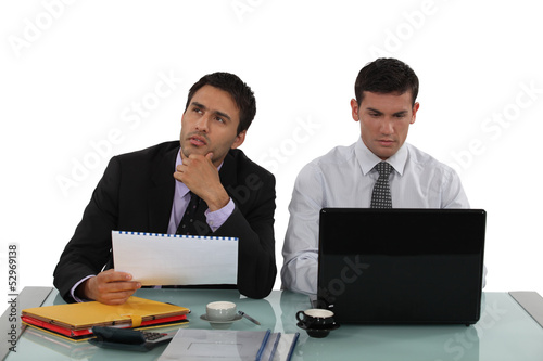 Photo: male colleagues working side by side male colleagues working side by side