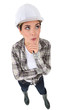 Photo: Woman in a hardhat deliberating a problem Woman in a hardhat deliberating a problem