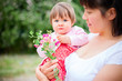 young mother playing with her ​​little daughter on nature