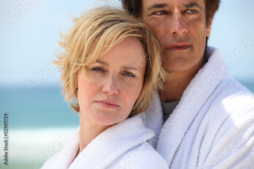 Photo: Couple at the beach wearing dressing gowns Couple at the beach wearing dressing gowns