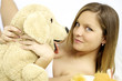 Happy cute blond woman with stuffed toy dog