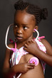 African Girl holding a stethoscope  to her heart
