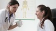 Two happy female doctors having a break at working place
