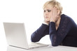 cute girl indifferently reading the content on the laptop