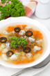 Fish soup with potatoes, carrots and olives closeup vertical
