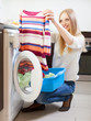   woman with color clothes near washing machine