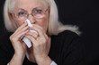 Photo: Elderly woman blowing her nose Elderly woman blowing her nose