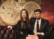 Foto: Beautiful woman and handsome young man sitting on a sofa Beautiful woman and handsome young man sitting on a sofa