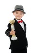Foto: Happy boy in black suit holding prize cup Happy boy in black suit holding prize cup