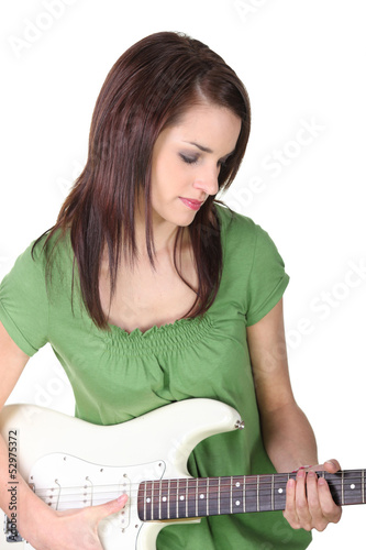 Photo: young woman playing guitar young woman playing guitar
