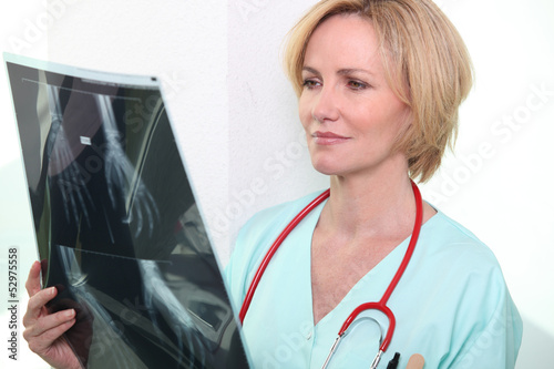 Photo: Female medic looking at x-rays Female medic looking at x-rays