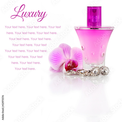 Photo: Diamond earrings, perfume and orchid flower with sample text Diamond earrings, perfume and orchid flower with sample text
