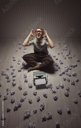 Photo: Frustrated man at typewriter Frustrated man at typewriter