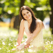 Cute woman rest  in the park with dandelions