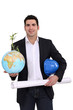 Photo: Architect holding globe and plans Architect holding globe and plans