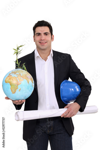 Photo: Architect holding globe and plans Architect holding globe and plans