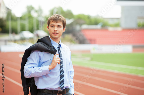 Photo: Businessman at athletic stadium and race track Businessman at athletic stadium and race track