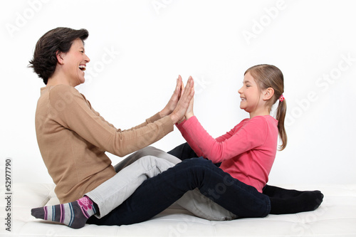 Photo: mother and daughter sharing moment of fun mother and daughter sharing moment of fun