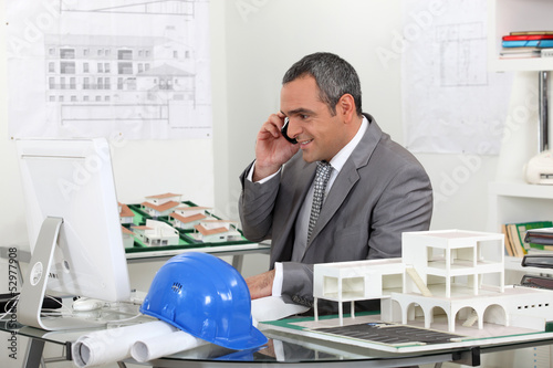 Photo: real estate businessman working in his office real estate businessman working in his office