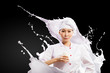 Asian female cook against milk splashes