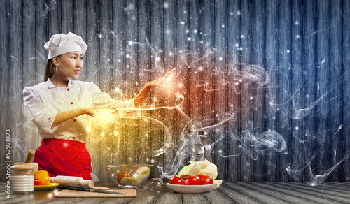 Photo: Asian female cooking with magic Asian female cooking with magic