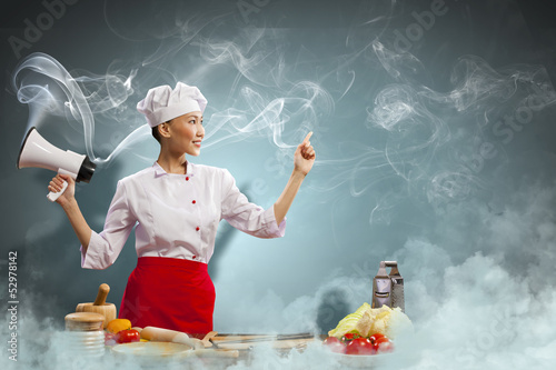 Photo: Asian female cook holding megaphone Asian female cook holding megaphone