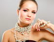 Portrait of pretty young woman with beads and bangle