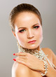 Portrait of pretty young woman with beads and bangle