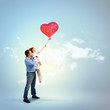 Foto: Father holding his daughter and a red heart Father holding his daughter and a red heart