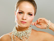 Portrait of pretty young woman with beads and bangle