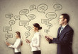 Three Businesspeople With Tabl...
